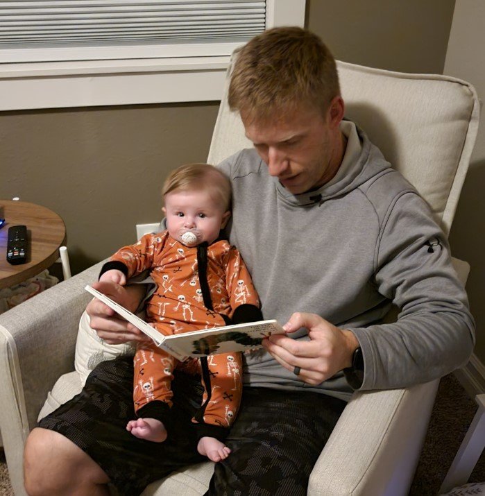 Palmer reading to his Baby